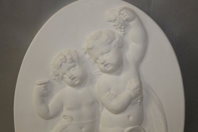 Pair of plaster bas-reliefs decorated with cherubs in the Louis XVI style, 20th century.