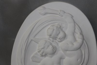 Pair of plaster bas-reliefs decorated with cherubs in the Louis XVI style, 20th century.