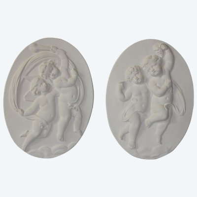 Pair of plaster bas-reliefs decorated with cherubs in the Louis XVI style, 20th century.