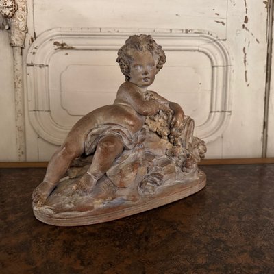 Terracotta statue representing Bacchus as a child on a barrel