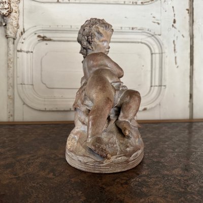 Terracotta statue representing Bacchus as a child on a barrel