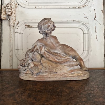 Terracotta statue representing Bacchus as a child on a barrel