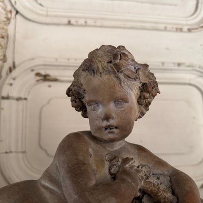Terracotta statue representing Bacchus as a child on a barrel