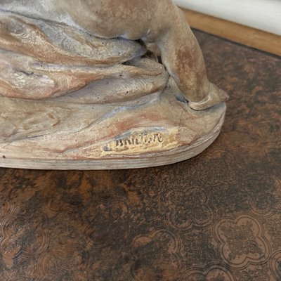 Terracotta statue representing Bacchus as a child on a barrel