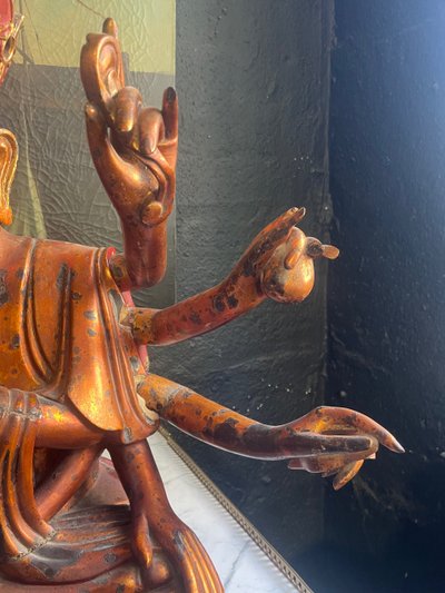 Vietnamese statue representing Quan Am in red and gilded wood