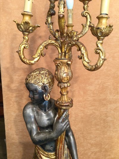 A large "Nubian" floor lamp in the Italian Baroque style, in painted and gilded wood.