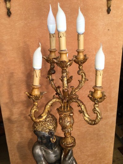 A large "Nubian" floor lamp in the Italian Baroque style, in painted and gilded wood.