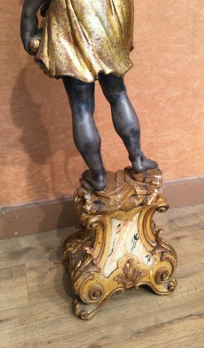 A large "Nubian" floor lamp in the Italian Baroque style, in painted and gilded wood.