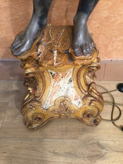 A large "Nubian" floor lamp in the Italian Baroque style, in painted and gilded wood.