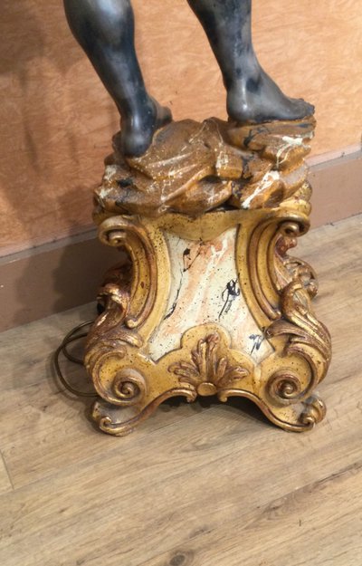 A large "Nubian" floor lamp in the Italian Baroque style, in painted and gilded wood.