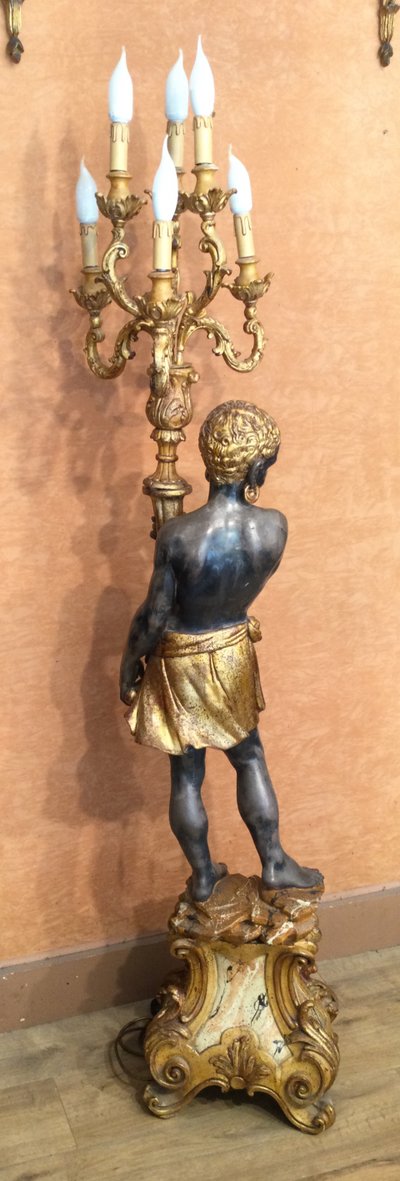 A large "Nubian" floor lamp in the Italian Baroque style, in painted and gilded wood.