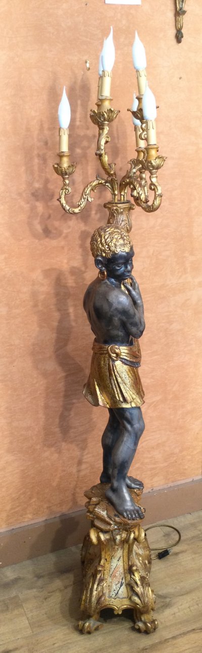 A large "Nubian" floor lamp in the Italian Baroque style, in painted and gilded wood.
