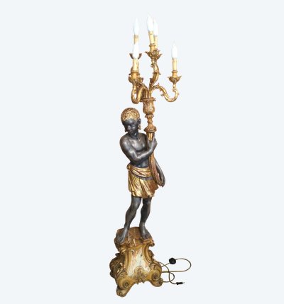 A large "Nubian" floor lamp in the Italian Baroque style, in painted and gilded wood.