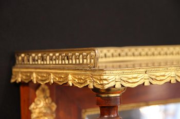 Showcase from the Empire period in mahogany and gilt bronze.
