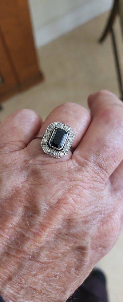 Platinum ring set with a blue sapphire and surrounded by Art Deco diamonds