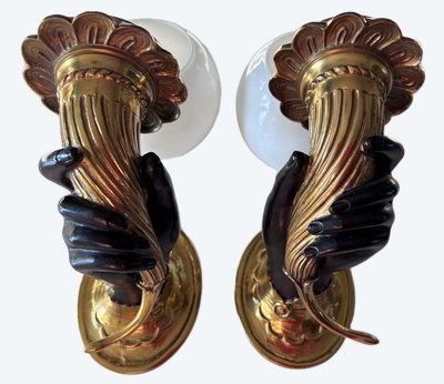 JANSEN Pair of bronze sconces depicting a Nubian hand holding a cornucopia