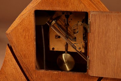 Exceptional and very elegant mantel clock, typical of the Amsterdam Art Deco school, in oak.