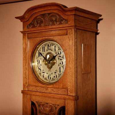 Impressive, magnificent Art Deco Dutch parquet clock in gilded oak.