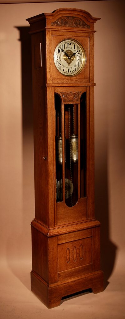 Impressive, magnificent Art Deco Dutch parquet clock in gilded oak.