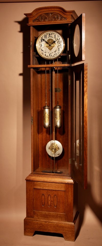 Impressive, magnificent Art Deco Dutch parquet clock in gilded oak.