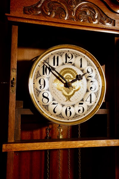 Impressive, magnificent Art Deco Dutch parquet clock in gilded oak.