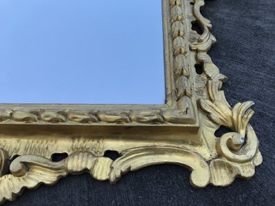 Antique Louis XV style gilded wood mirror from the 20th century