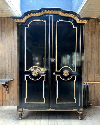 Large wardrobe in blackened and gilded wood