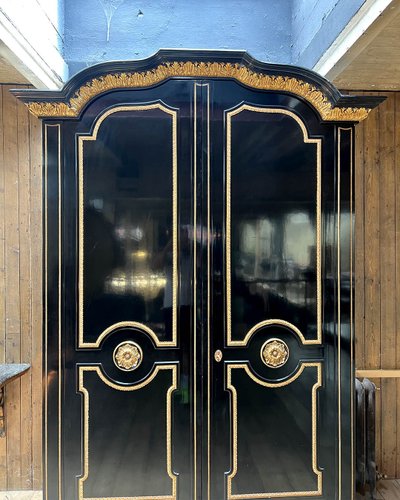 Large wardrobe in blackened and gilded wood