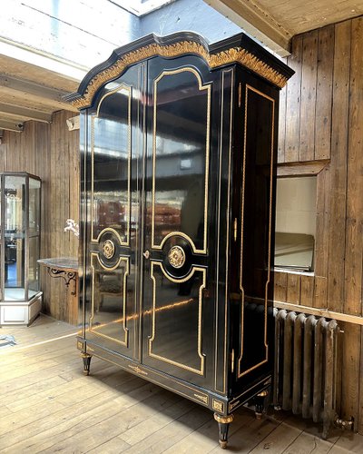 Large wardrobe in blackened and gilded wood
