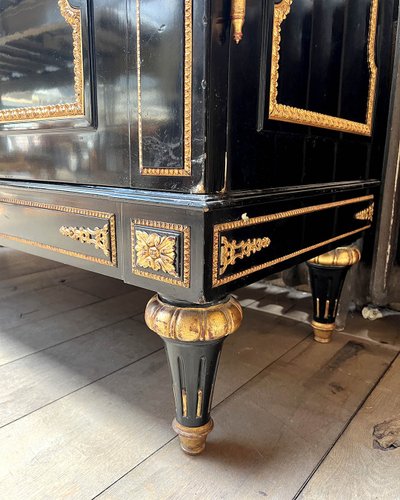 Large wardrobe in blackened and gilded wood