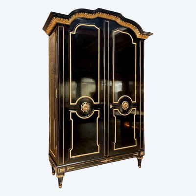 Large wardrobe in blackened and gilded wood