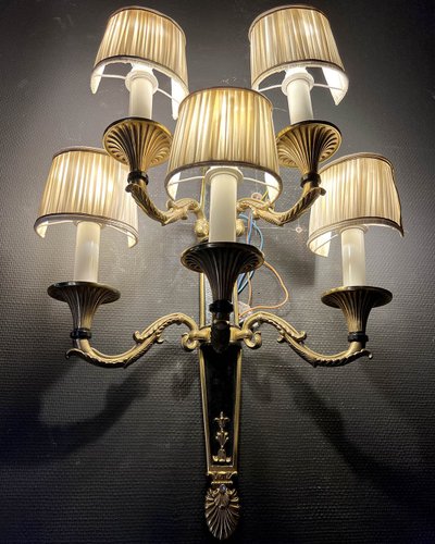 Pair of patinated bronze and gilt bronze wall lights with five arms