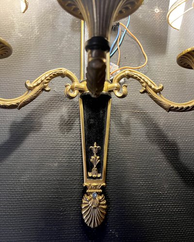 Pair of patinated bronze and gilt bronze wall lights with five arms