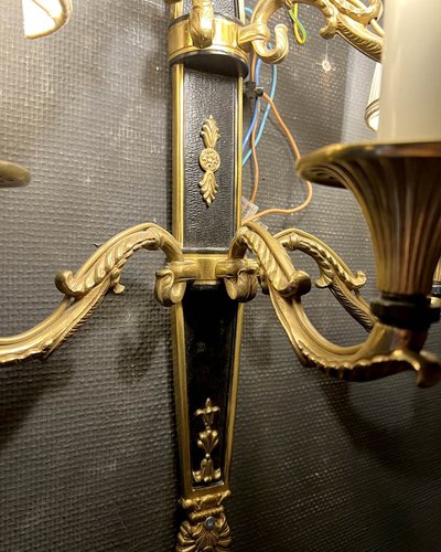 Pair of patinated bronze and gilt bronze wall lights with five arms