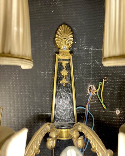 Pair of patinated bronze and gilt bronze wall lights with five arms