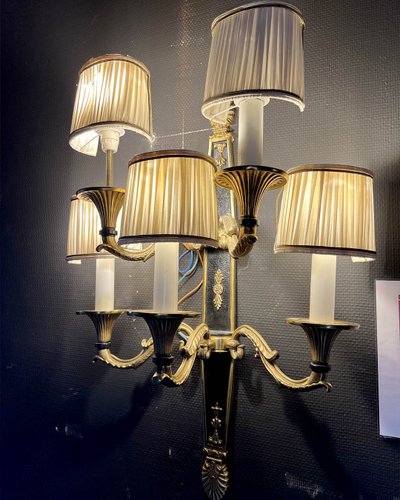 Pair of patinated bronze and gilt bronze wall lights with five arms