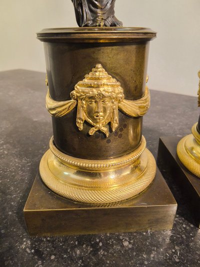 Pair of Candlesticks with Antique Figures and Poppies in patinated and gilded bronze, Directoire period.