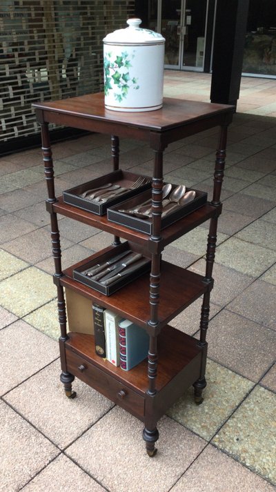 A shelf that can be used as a bookcase or a serving trolley