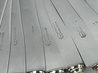 12 table knives with ebony handles and pearl decoration