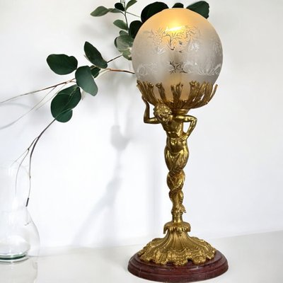 LAMPADA DEL XIX SECOLO IN BRONZO DORATO CHE RAPPRESENTA UN TRITONE CON BASE IN MARMO A DOPPIA CODA