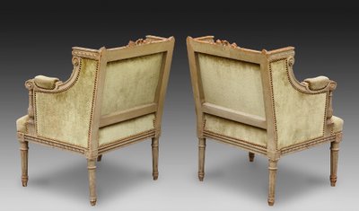 une paire de bergères en bois sculpté, peint gris vert, fin XIXème siècle 