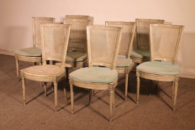 suite de 12 chaises de style Louis XVI en bois polychrome -19° siècle