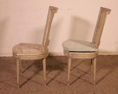 suite de 12 chaises de style Louis XVI en bois polychrome -19° siècle