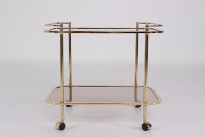 Rollendes Beistelltischchen aus Messing und Rauchglas 1970.