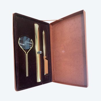 Box with magnifying glass, paper cutter and line puller.