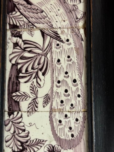 Three manganese Delft tiles forming a portrait of a peacock, 18th century