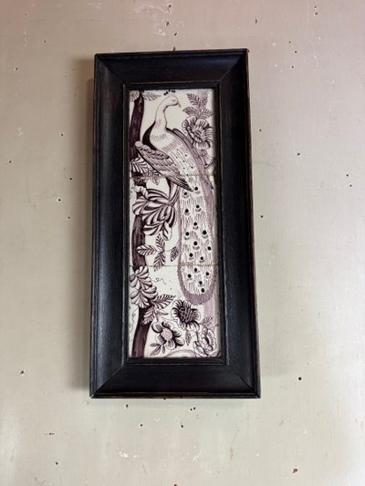 Three manganese Delft tiles forming a portrait of a peacock, 18th century