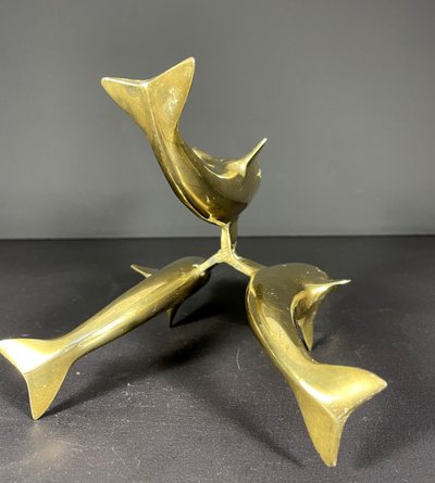 France, Ostrich egg mounted on a brass tripod base with a representation of dolphins, 1970.