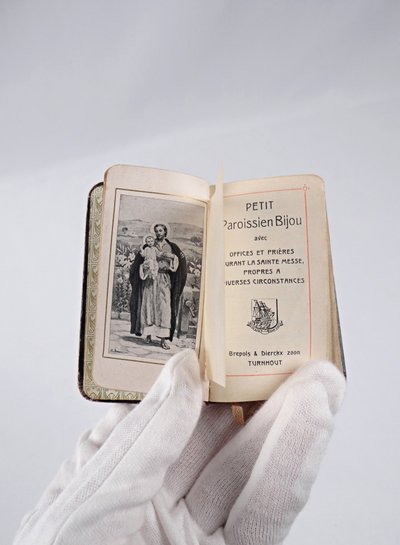 A small, pocket-sized parishioner's book, complete with offices and prayers during Holy Mass.