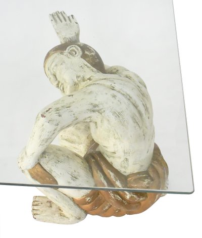 Coffee table with two figures holding a glass tray